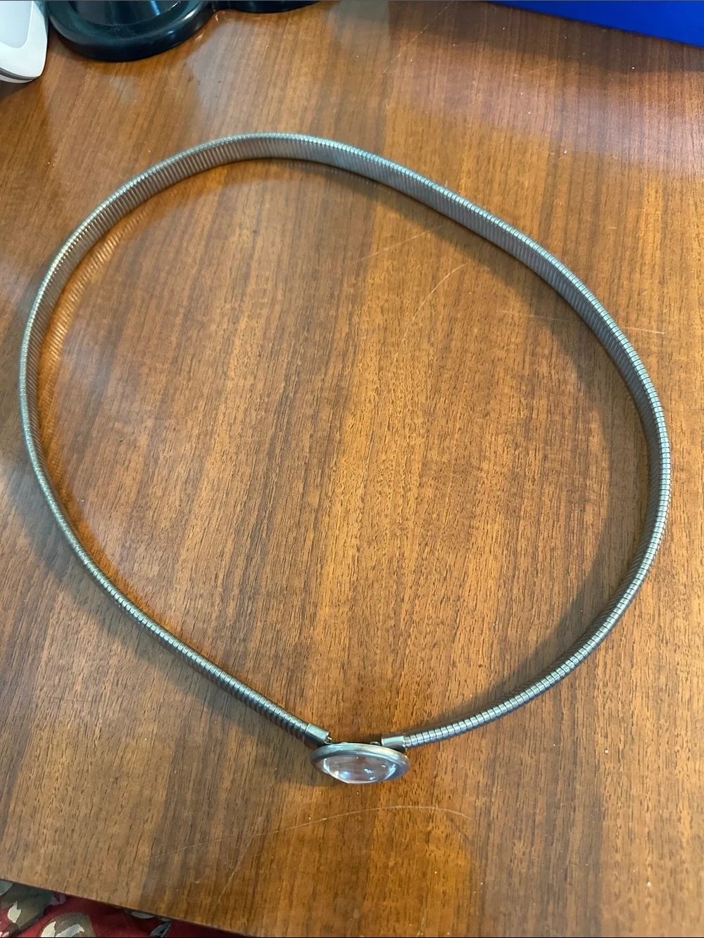 Vintage 80s silver metallic stretch snake belt with an oval cabochon center